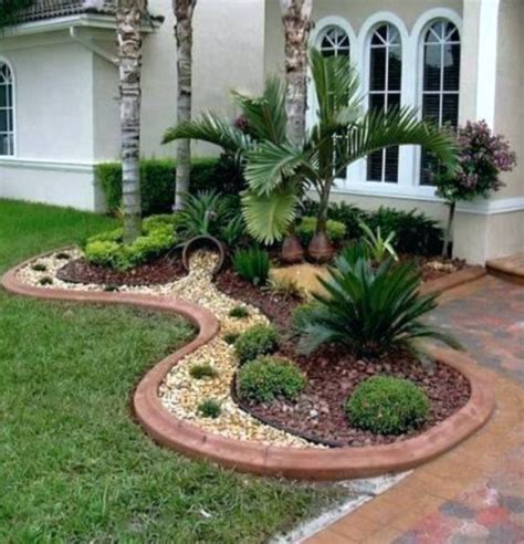 Get 5 landscaping ideas to turn a bleak front lawn and driveway into a lush, livable garden. Love this look ! The pot looks like its spilling rocks ...