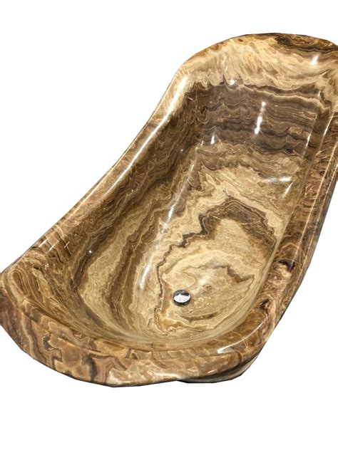 This onyx marble bathtub is hand carved from one nature solid onyx block, abosutlely shining polished. Onyx Marble in London