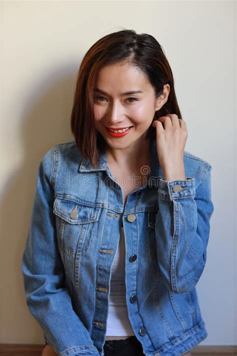 Side View Young Adult Asian Woman Red Lip And Short Hair In Blue Jean
