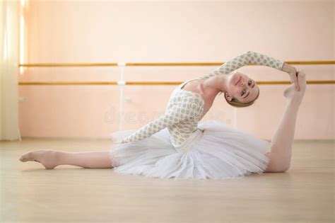 Beautiful Ballerina In Body And White Tutu Is Training In A Dance Class