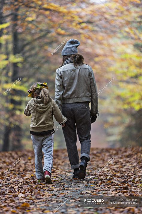 Mother And Daughter Walking In Autumn Forest — Exploration Wearing