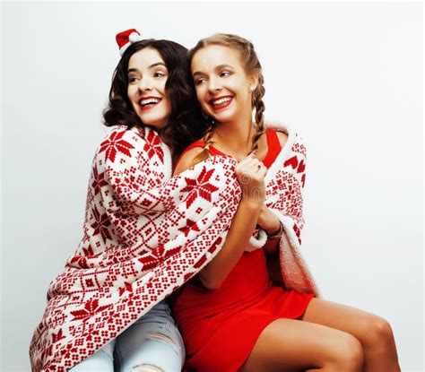 Young Pretty Happy Smiling Blond And Brunette Woman Girlfriends On Christmas In Santas Red Hat