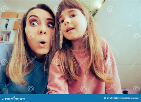 Mother And Little Toddler Girl Trying To Take Silly Selfies Stock Image
