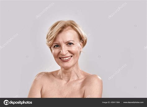 Close Up Portrait Of Attractive Middle Aged Woman Smiling At Camera