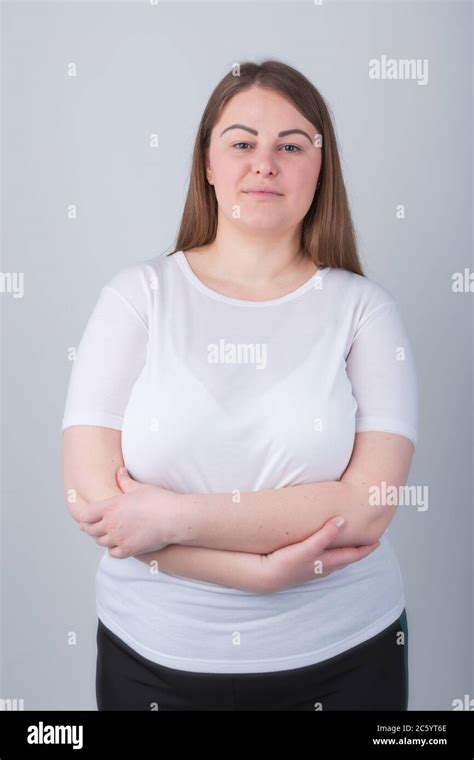Beautiful Chubby Girl In 30s Posing In Studio Wearing Casual White T