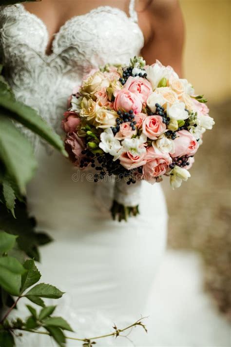 Beautiful Tender Wedding Bouquet Of Roses And Eustoma Flowers In Hands