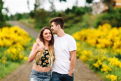 Young Teen Couple In Love Walking Down A Country Road By Stocksy