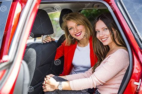 Girls In Back Seat Of Car Looking Out Open Door Stock Photo Image Of