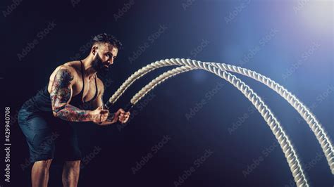 Muscular Man Working Out With Heavy Rope Photo Of Man With Naked Torso Strength And Motivation