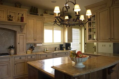 It felt sooooo good to remove that dated piece of curvy wood over the sink, then paint the cabinets. move DR chandelier to over the peninsula | Kitchen ...