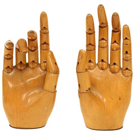 Two Wooden Hand Sculptures Made To Look Like Human Hands