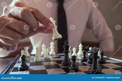 Closeup Photo Of Businessman Playing Chess And Beating Black Kin Stock