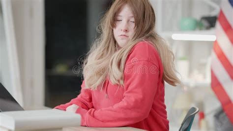 Exhausted Teenage Asian Redhead Girl Sleeping At Desk Indoors Portrait Of Tired Teenager Waking