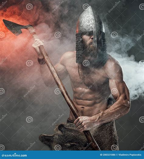 Warlike Shirtless Viking With Axe Posing In Dark Background Stock Photo