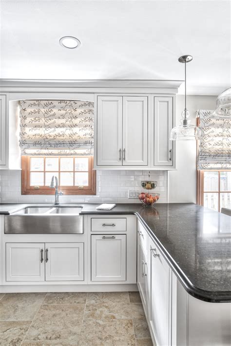 Kitchen island with bar stools. Clean White Kitchen with Black Counter Tops - Transitional ...