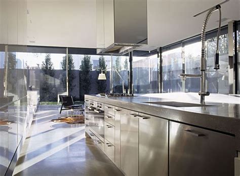 Small kitchen renovation with dark cabinets, contrasting center island, granite countertops, custom back splash and stainless steal appliances. Modern Interior Design for a Contemporary Concrete House ...