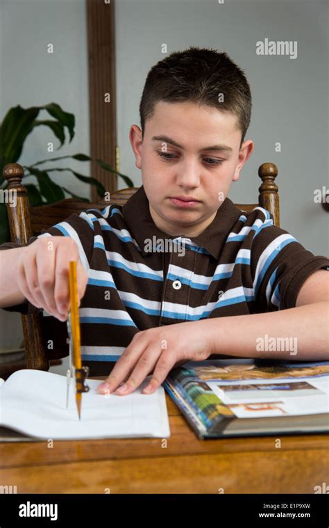 A Teenage Boy Doing His Homework Stock Photo Alamy