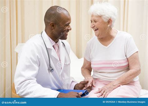 Doctor Giving Checkup To Woman In Exam Room Stock Photo Image Of Caucasian Examination