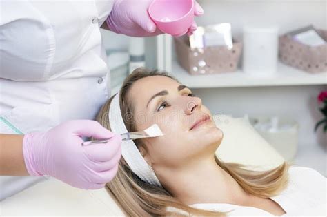 Cosmetology Young Woman Receiving Facial Cleansing Procedure In Beauty