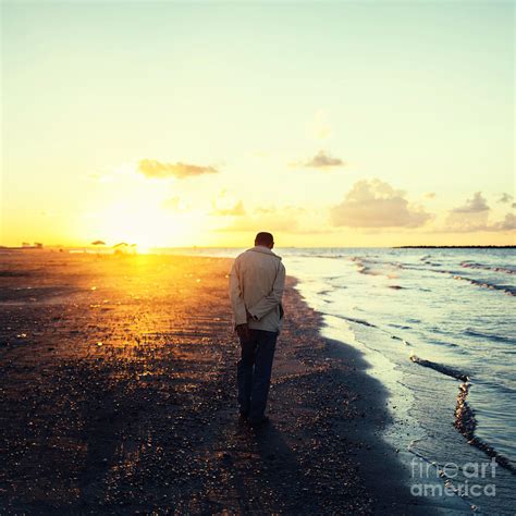 Lonely Man Walking On The Beach At Sunset Photograph By Mohamed