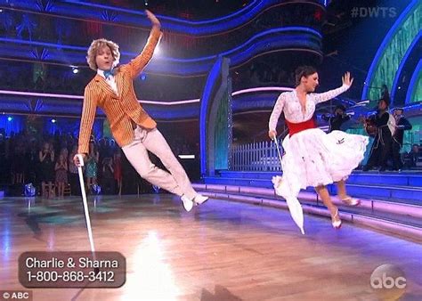 Two People Dancing On A Dance Floor With One Person Holding A Cane And