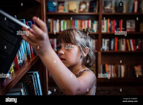 Child At Library Bookstore Looking At Books Stock Photo Alamy