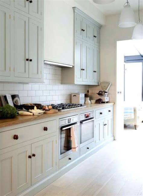 The right tiling will enhance the beauty of your kitchen units while we've discovered a great range of kitchen floor tiling ideas that take the traditional and turn it on its head. light green cabinets, light floor, white subway tile ...