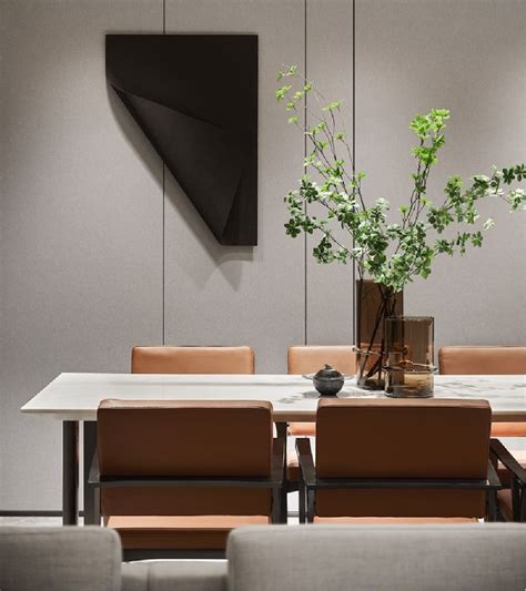 a dining room table with chairs and a vase filled with flowers