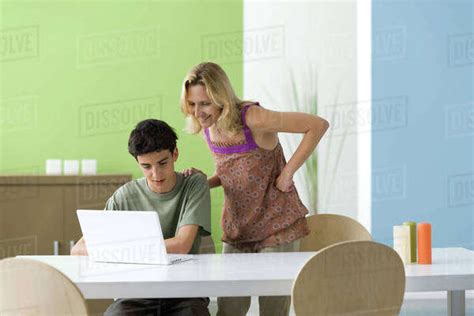Teenage Boy Showing Mother Laptop Computer Stock Photo Dissolve