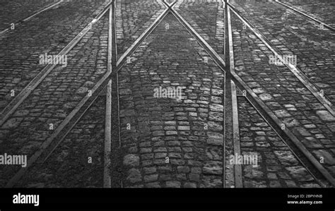 Crossing Of Tram Rails On Stone Pavement Black And White Background
