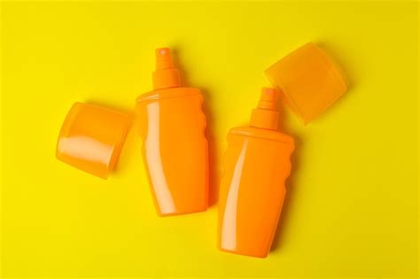 Premium Photo Orange Bottles Of Sunscreen On Yellow