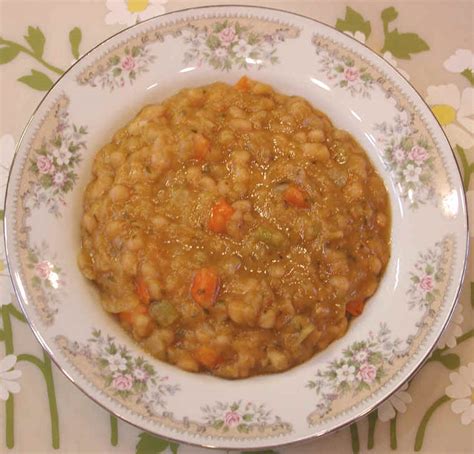 Add the tomatoes with juice, onion, ham hock, broth, water, salt and pepper. Navy Bean Soup: An All Creatures American International ...