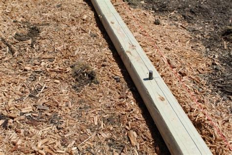 This system uses 2 rows of landscape timbers stacked on top of each other. DIY - How To Build a Playground Border - The Home Team