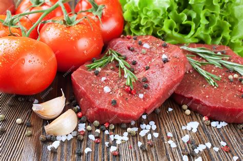 Premium Photo Raw Beef Steak With Vegetables And Spices