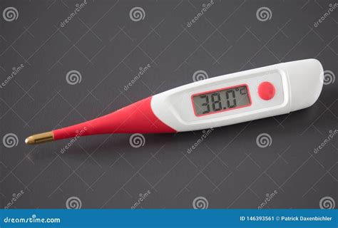 Red Fever Thermometer With Digital Display And Pills Lying On The Desk