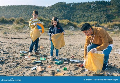 Young Volunteers Cleaning The Beach Stock Photo Image Of Male