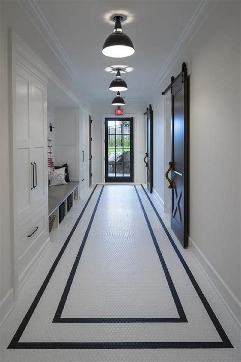 Black And White Hexagon Floor Tiles In A Galley Mudroom Feature Two Black Borders That Visually