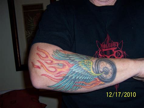 winged-wheel-with-flames-tattoo-arm-color-wings-tattoo-arm,-flames-tattoo,-arm-tattoo