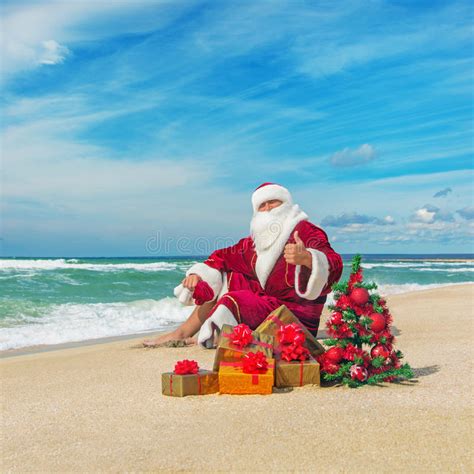 Santa Claus At Sea Beach With Many Ts And Decorated Christmas Stock