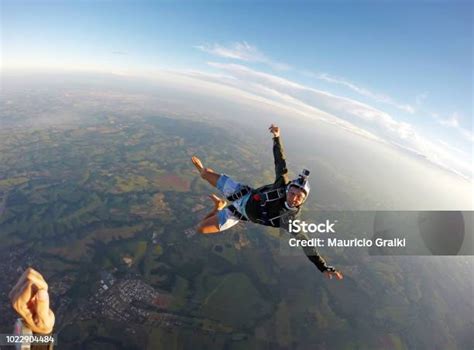 Barefoot Man Jumping From Parachute At Sunset Stock Photo Download