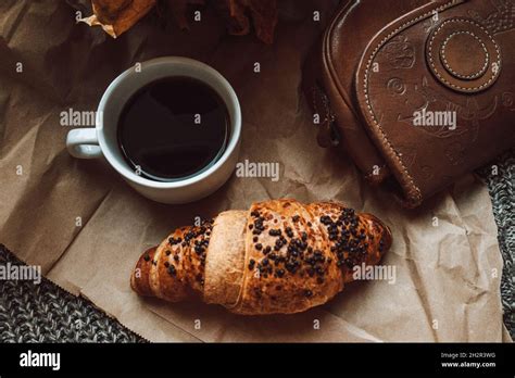 A Cup Of Black Morning Coffee With A Chocolate Croissant Delicious