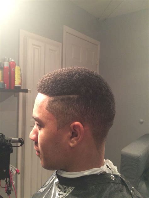 Close Fade On Black Hair With Pointed Sideburns And Straight Part