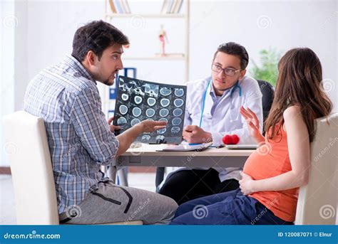 The Pregnant Woman With Her Husband Visiting The Doctor In Clinic Stock Image Image Of Husband