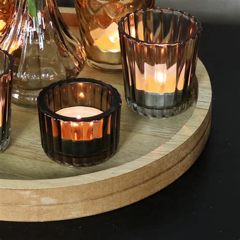 It is also waterproof to help protect any surface you rest it on. Glass Vase & Tealight Holders on Wooden Tray