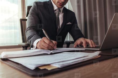 Businessman Working At His Office Desk Stock Photo 136638