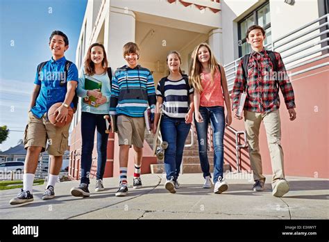 Teenagers Walking Out Of School Stock Photo Alamy