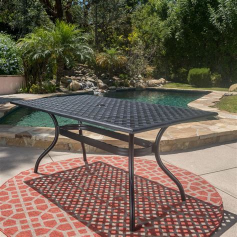 An outdoor dining table can have as many uses as you have things to put on it. Noble House Cayman Black Sand Rectangle Aluminum Outdoor ...