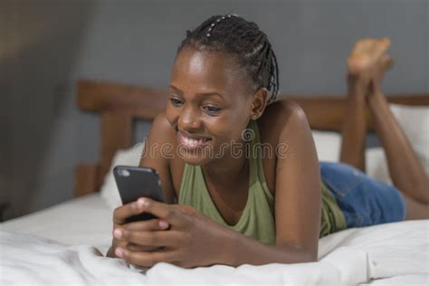 Lifestyle Home Portrait Of Young Happy And Attractive Black African American Woman Lying On Bed