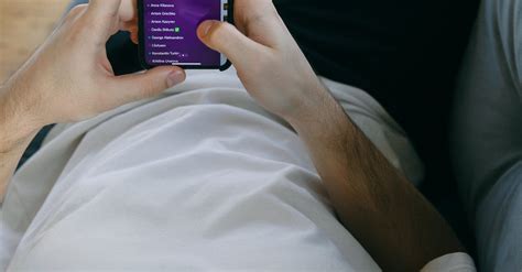 Man Lying Down Holding His Smartphone · Free Stock Photo