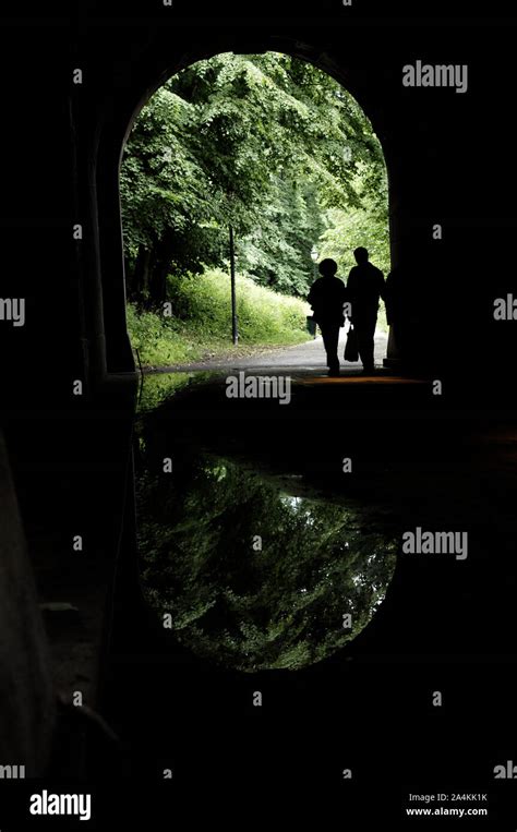 Couple Walking Through Tunnel Stock Photo Alamy